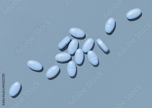 Blue medical pills on blue top view, hard light. Pharmaceutical products for healthcare