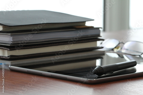 Minimal Office Setup with Books and Tablet