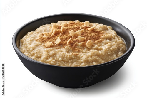Creamy oatmeal topped with cinnamon and crunchy toppings in a sleek black bowl