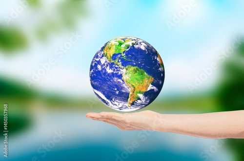 Fototapeta Naklejka Na Ścianę i Meble -  Earth on man hand on blurred of lake background. Environmental protection concept. Elements of this image furnished by NASA.