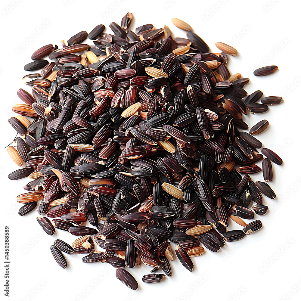 A small pile of dark purple and brown rice grains scattered on a white surface casting a soft shadow.