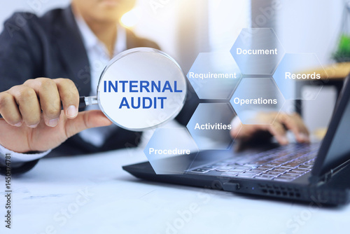 Internal audit concept with an auditor holding a magnifying glass to check the internal operations of the company to ensure compliance with ISO standards.