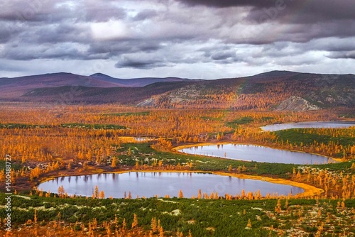 Northern autumn landscape with lakes and mountains.