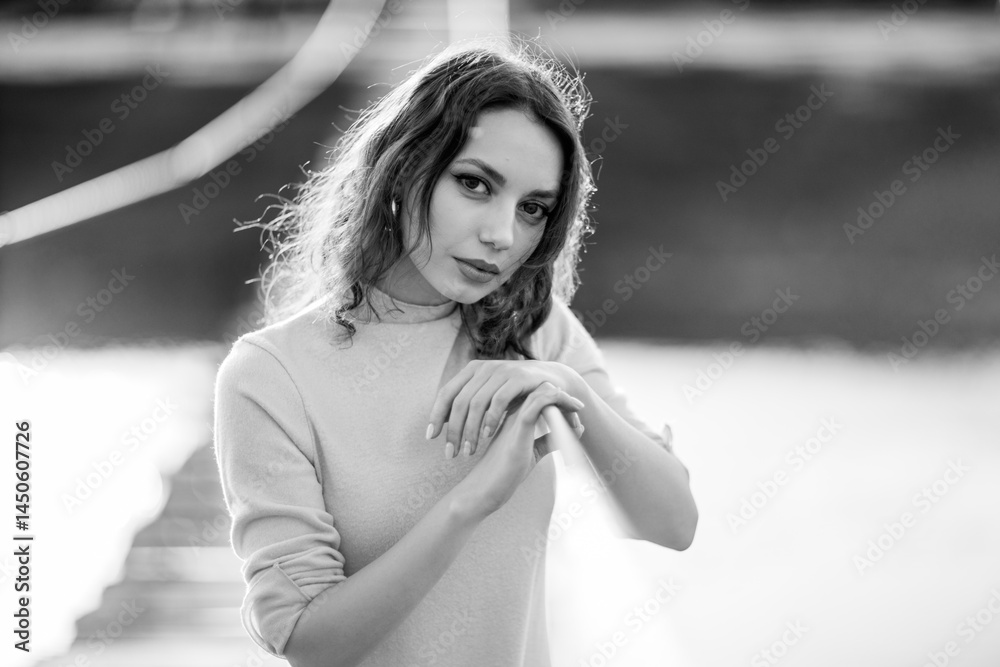 beautiful brunette european girl in blue trench coat at nature. Young lady with beautiful face and lips.