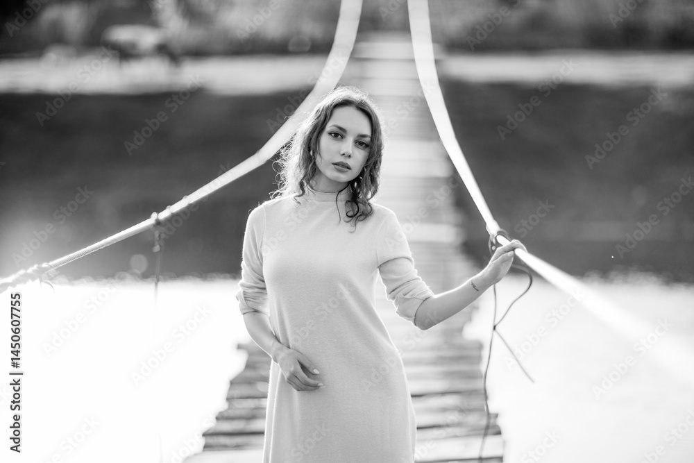 beautiful brunette european girl in blue trench coat at nature. Young lady with beautiful face and lips.