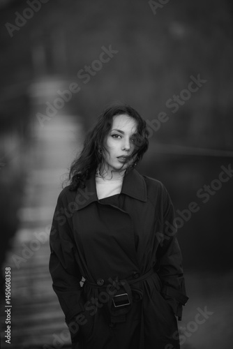 Obraz na płótnie beautiful brunette european girl in blue trench coat at nature. Young lady with beautiful face and lips. w salonie
