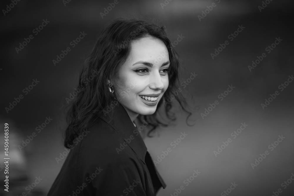 beautiful brunette european girl in blue trench coat at nature. Young lady with beautiful face and lips.