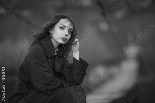 Obraz na płótnie beautiful brunette european girl in blue trench coat at nature. Young lady with beautiful face and lips. w salonie