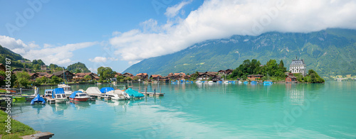 harbor with moored boats, tourist resort Iseltwald, lake Brienzersee, switzerland