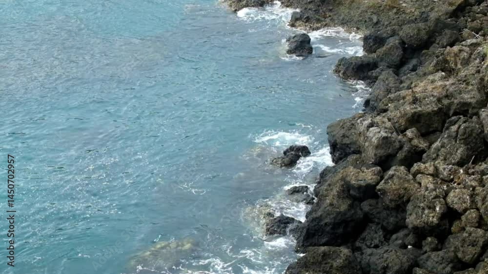 Top view slow motion of calm ocean waves on rocky shore. Ecology, environment and vacation concept. 4K footage Top view slow motion of calm ocean waves on rocky shore. Ecology, environment and vacation concept. 4K footage