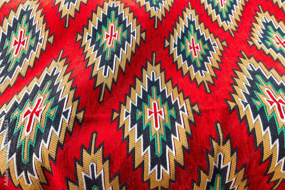 Geometric pattern in a brightly colored woven rug.