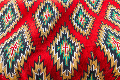 Obraz na płótnie Geometric pattern in a brightly colored woven rug. w salonie