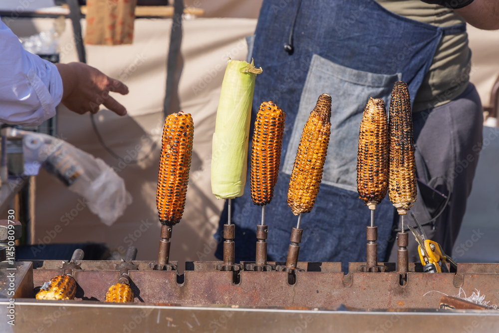 Roasted corn for sale at an outdoor market.