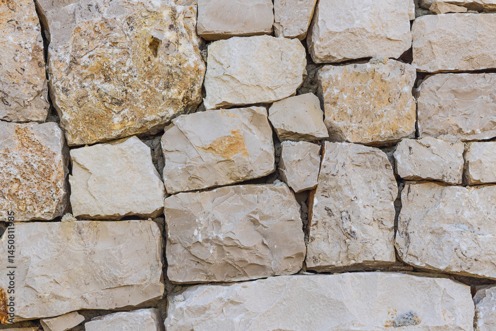 Patterns in a rough cut stone wall.