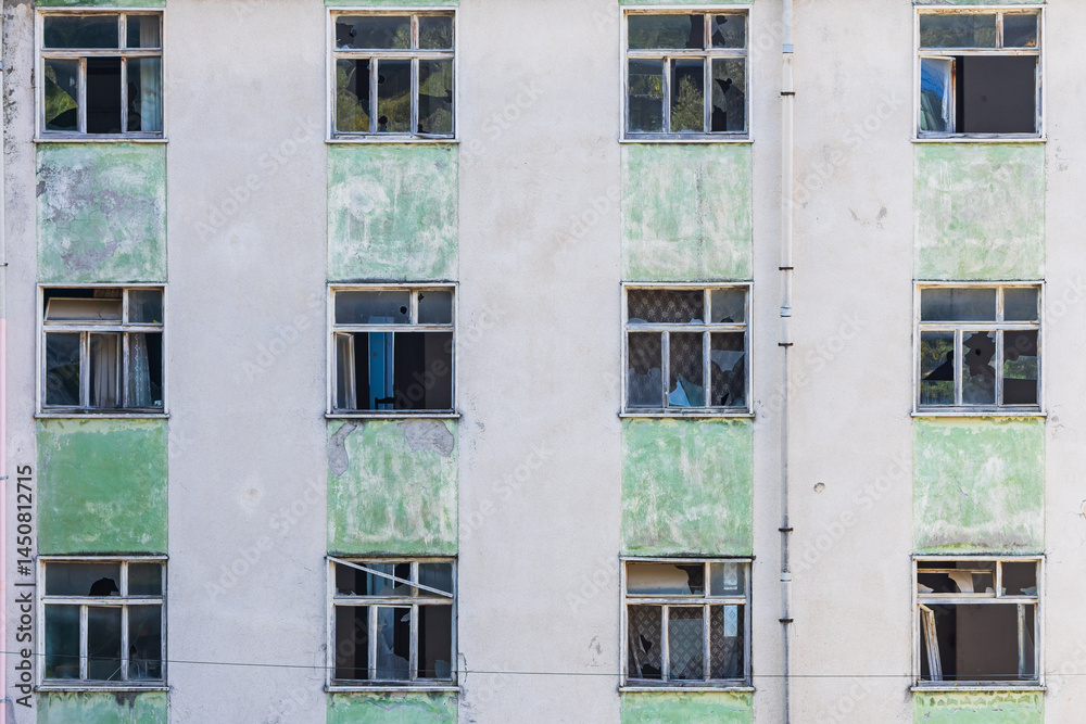Broken windows in an abandoned apartment building.