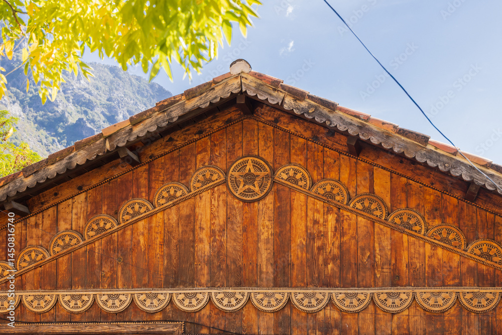 Decorations under the eaves of a traditional wooden building in Albania.