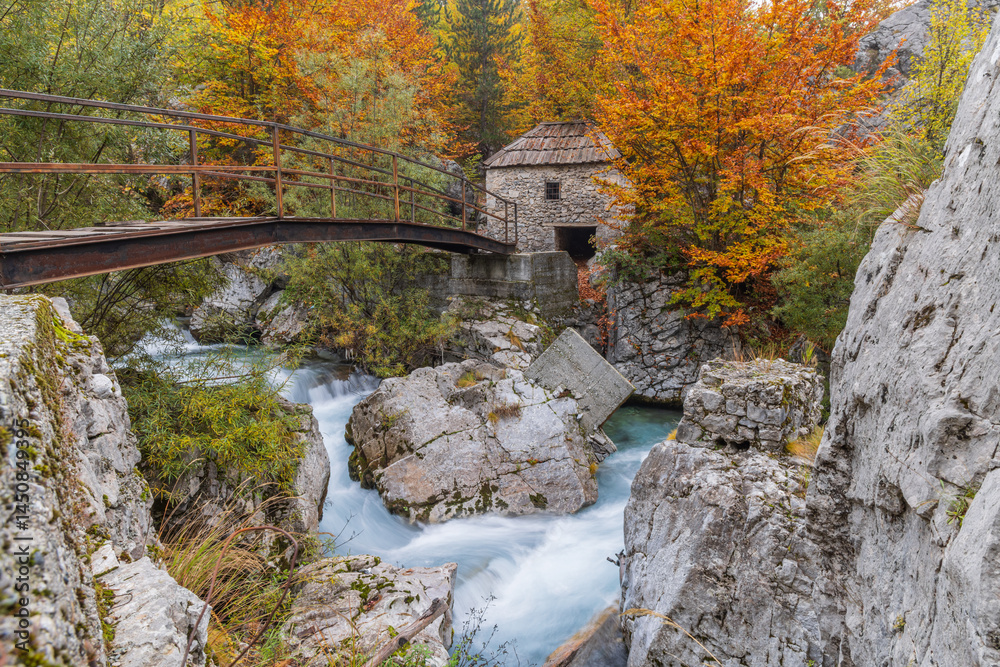 An old stone grist mill and footbridge on the Valbonas River in Valbona Valley National Park.