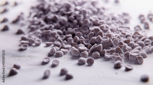 Close-up of scattered plant-based bioplastic granules on light background, ideal for sustainability visuals, eco packaging, and green technology campaigns