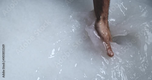 Super Slow Motion of Hand Stirring White Paper Pulp in Vat During Traditional Papermaking Process - Close-Up of Artisan Mixing Slurry for Sheet Formation in Handmade Paper Craft Workshop at 1000 fps.