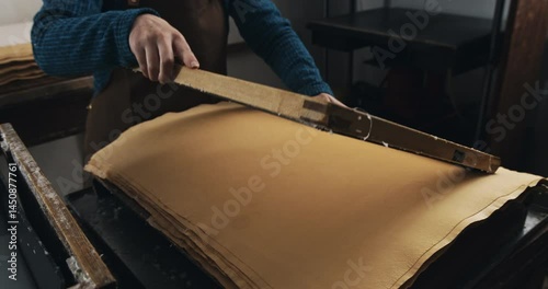 Super Slow Motion of Traditional Handmade Paper Making Process with Wooden Frame Being Lifted from Water Vat in Artisan Workshop Showing Wet Pulp Sheet Formation at 1000 fps