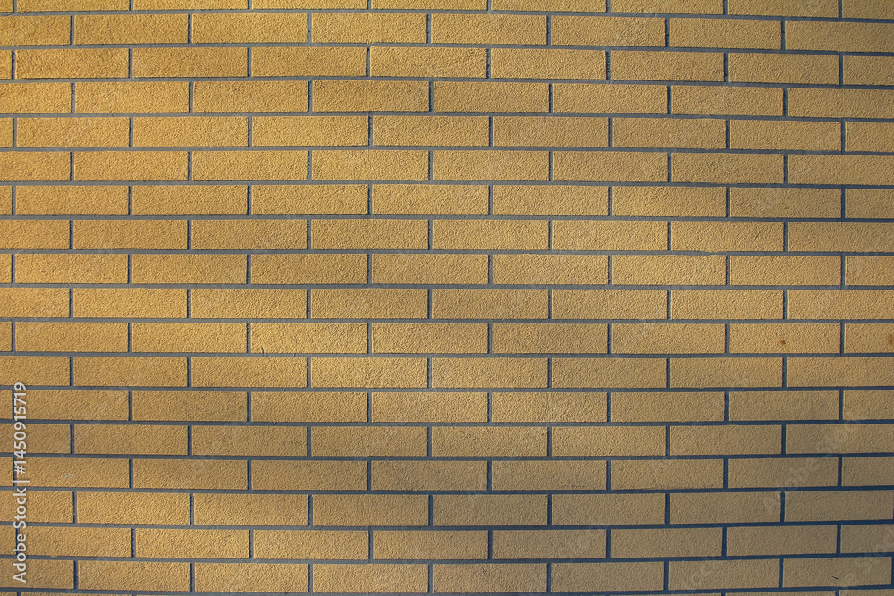 Fototapeta premium Uniform Yellow Brick Wall Texture With Horizontal Pattern Creating Minimalist Background Design