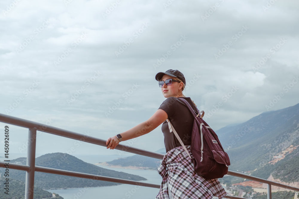 Fototapeta premium Eco-conscious solo traveler exploring rural landscapes, embracing nature, mindfulness, and sustainability. Concept of green tourism, digital detox, and slow travel for self-discovery and harmony.