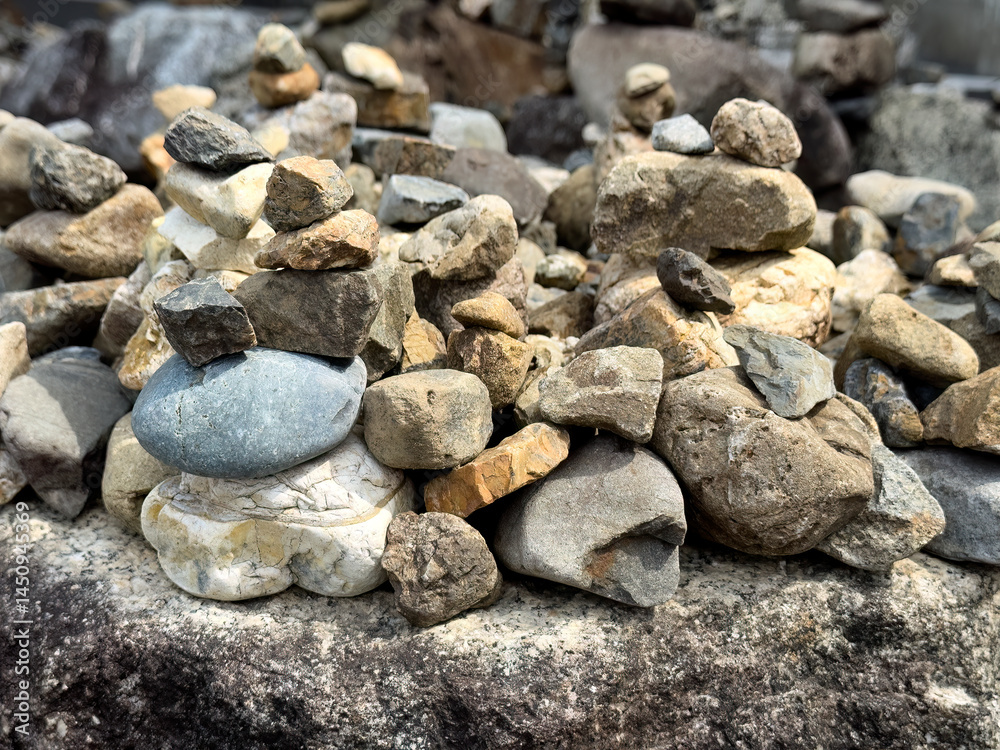 Background of a pile of rocks with some stacked in tower formation