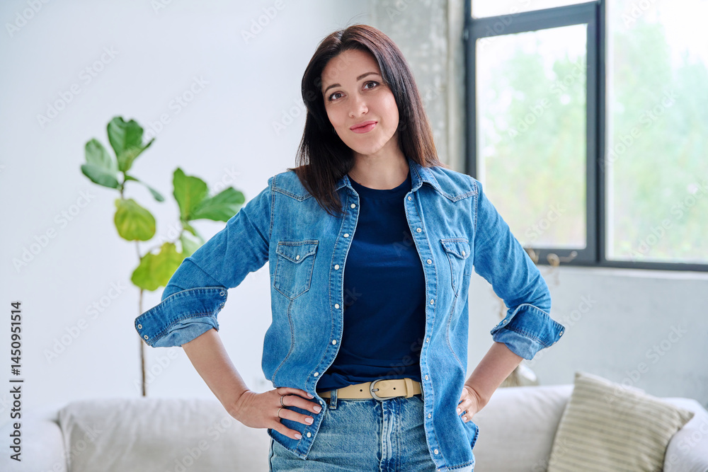 Portrait of beautiful young smiling woman in home interior