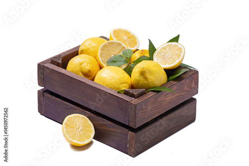 Fresh and ripe lemons on wooden box isolated on white