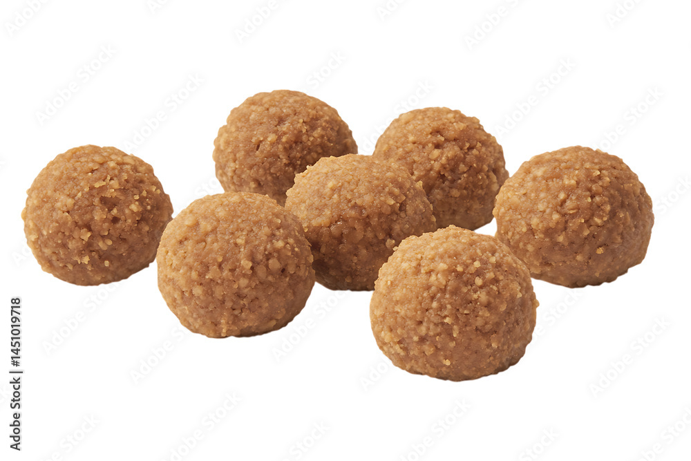 Seven ladoos arranged on a plain dark background in studio lighting Seven ladoos arranged on a plain dark background in studio lighting