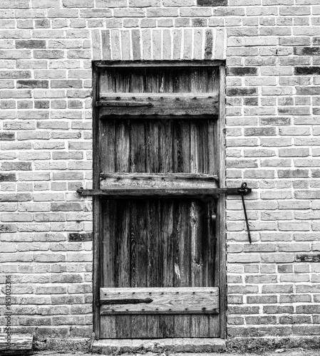 Old weathered wood barn wall, door and window