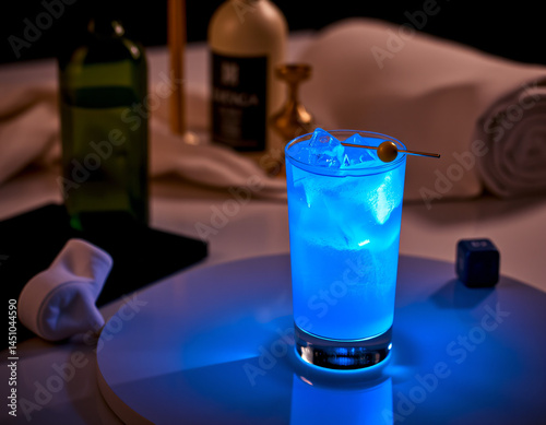 Blue Curacao cocktail with an electric blue glow in a designer glass, perfect for luxury drink presentations and branding