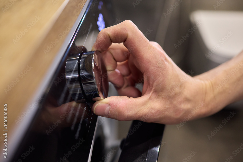 Individual Interacting with a Modern Washing Machines Control Panel for Efficient Laundry Tasks