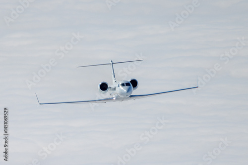 Frontal view of a Gulfstream IV (business jet) over  cloud layers