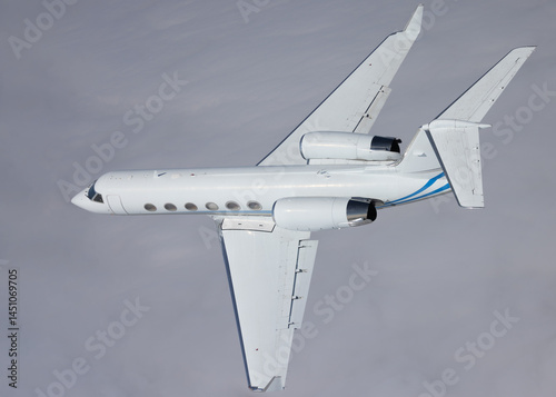 Side view of a Gulfstream IV (business jet) over  cloud layers, in beautiful light photo