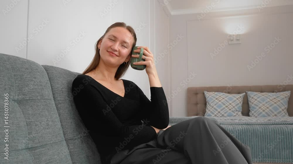 Serene young woman savoring aromatic hot beverage, breathing in rich scent from elegant green mug during peaceful morning moment, experiencing sensory enjoyment Serene young woman savoring aromatic hot beverage, breathing in rich scent from elegant green mug during peaceful morning moment, experiencing sensory enjoyment