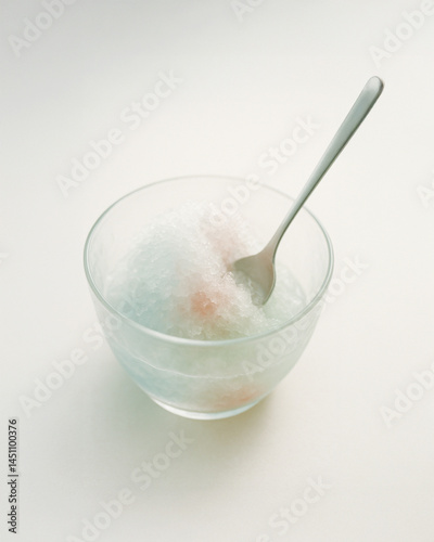 Obraz na płótnie Pastel shaved ice dessert in glass bowl with spoon and melting texture w salonie