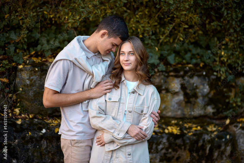 Fototapeta premium Embracing Teen Love in the Greenery of the Park.