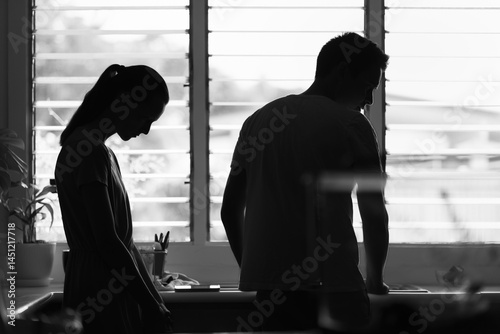 silhouette of a young couple upset, having disagreement, relationship problem, misunderstanding	