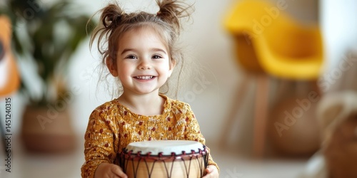 a little girl playing a drum with her hands 