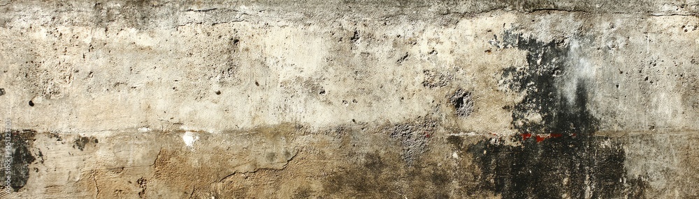 Close-up of a weathered wall texture with peeling paint and earthy tones.