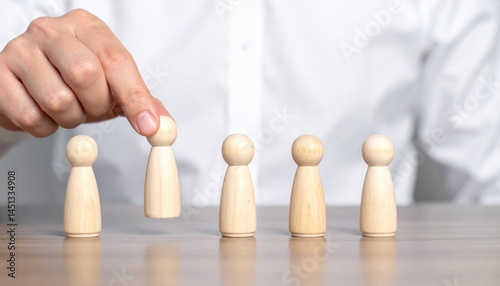 Businessman selecting wooden figurine for hiring process office setting conceptual image professional environment