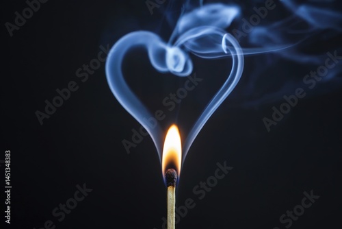 urning match with heart shaped smoke on black background