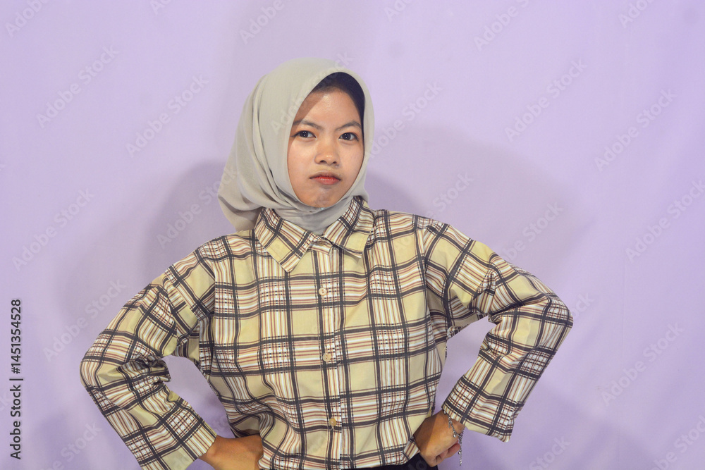 Fototapeta premium Young Indonesian woman thinking on isolated background