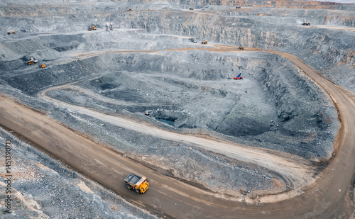 Panoramic of open pit mine industry, aerial view. Big yellow mining truck for coal working in quarry