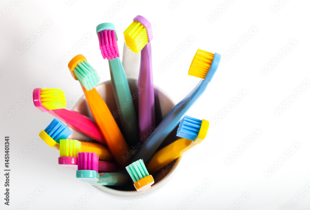 A set of multicolored toothbrushes isolated on white background. Design concept for dental and oral health theme.