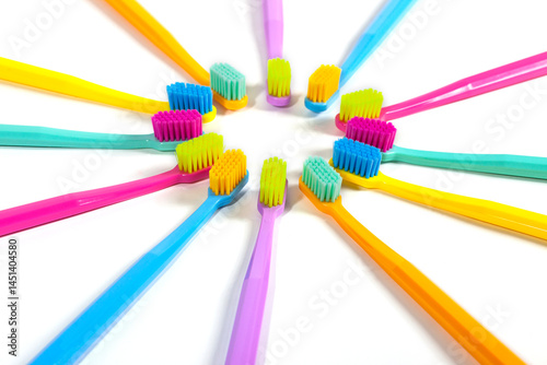 Obraz na płótnie A set of multicolored toothbrushes isolated on white background. Design concept for dental and oral health theme. w salonie