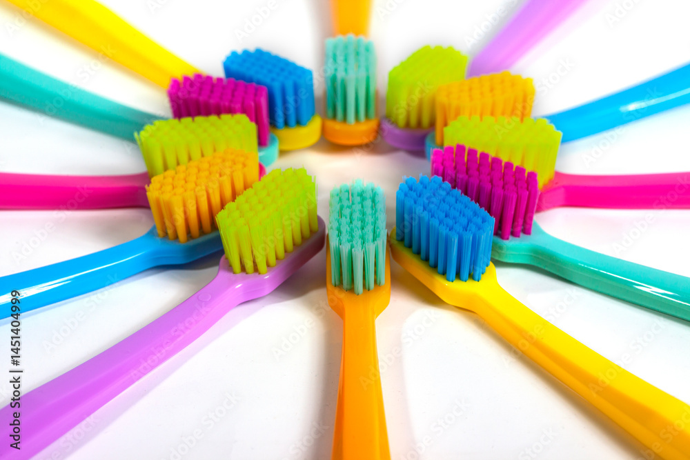 A set of multicolored toothbrushes isolated on white background. Design concept for dental and oral health theme.