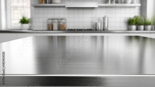 Empty stainless tabletop with blurred kitchen view background.
