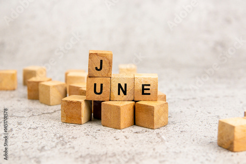 Wooden blocks with June text isolated on gray background